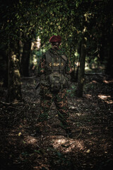 Portrait of an eastern special forces soldier with rifle in woodland