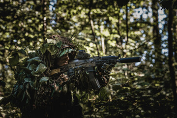 Eastern special forces soldier with rifle in woodland - 532516219