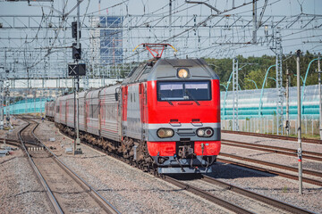 Passenger train moves at autumn time.