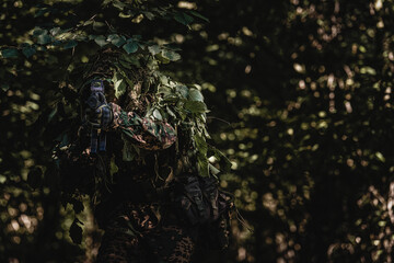 Eastern special forces soldier with rifle in woodland - 532516236