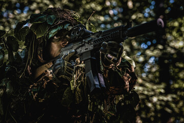 Eastern special forces soldier with rifle in woodland