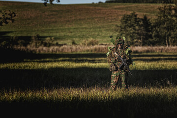 Eastern special forces soldier with rifle in woodland - 532516257
