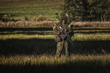 Eastern special forces soldier with rifle in woodland - 532516270