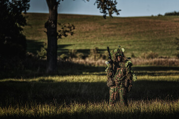 Eastern special forces soldier with rifle in woodland - 532516279