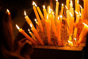 Burning Candles in the Buddhist Temple with a Woman