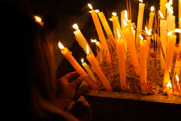 Burning Candles in the Buddhist Temple with a Woman