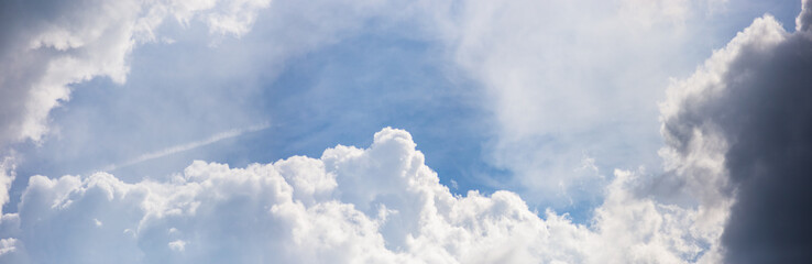 Sky panorama. Beautiful white big clouds in the blue sky. Landscape of the power of heaven and nature. Copy space