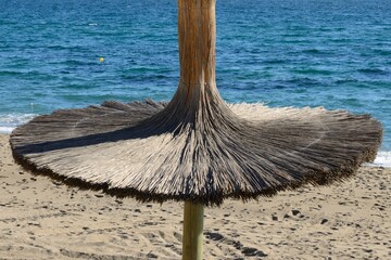 Beach umbrella and sea  in Marbella, Spain. - 532518033
