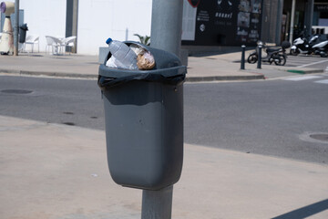 Full trash bin on the street