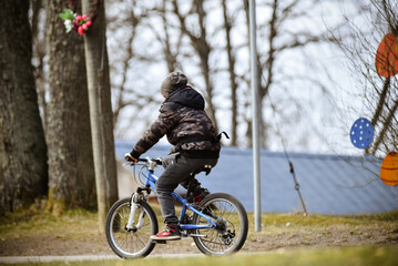 A child rides a bicycle in a country park