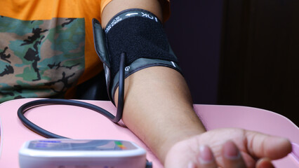 Fototapeta na wymiar Man is Measuring blood pressure with machine.