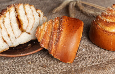 Sweet homemade freshly baked bun on the table. Close-up.