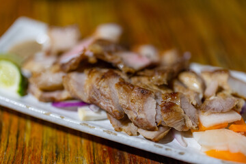 Grilled slice of pork dish in restaurant