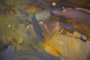 Close up detail of brushstrokes in acrylic and oil paint on an artist's palette.