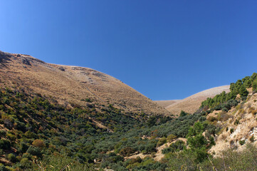 Hills on the western side of the Sea of Galilee and cloudless blue sky
