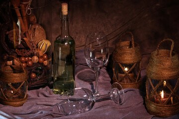 Fototapeta na wymiar Vintage naturmort with bottle of wine and candles. Still life photography.