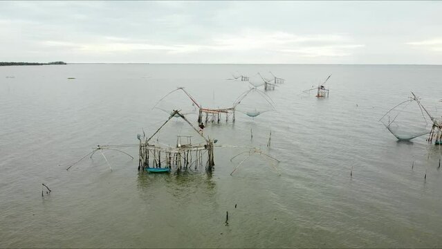 The giant fishing constructions, It is signature fishing trap and traditional fishing style of Pak Pra fishing village, Phatthalung, THAILAND. (2.7K resolution footage by drone)