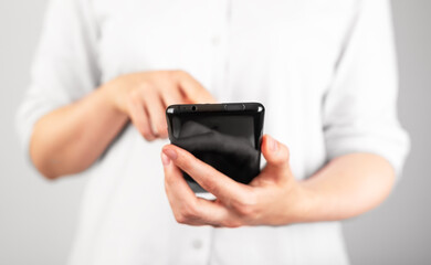 Woman hand clicking or swiping phone screen. Using smartphone in daily life for study, work, leisure.