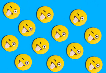 Smileys in the form of gingerbread on the blue background. Flat lay.