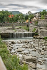 Mountain village with river and vegetation