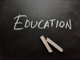 Education word written on blackboard or slate with chalk.