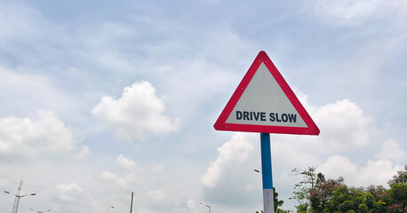 Traffic rules and signs board on road for drive slow for the driver as warning.