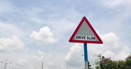 Traffic rules and signs board on road for drive slow for the driver as warning.