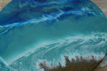 Epoxy resin art. Imitation of the sea. Sea foam. Modern trendy hobby. Macro photo. Pouring process