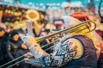 Jazz musician playing trumpet in Santa Claus costume, Christmas performance