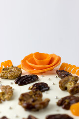 Carrot cake with cream cheese decorated with nuts and carrots