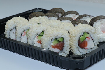 Japanese food. Sushi roll set. Big fresh set. Eat sushi with chopsticks.