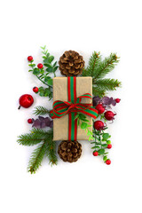 Christmas decoration. Gift boxes, branch christmas tree, red berries, cones on a white background with space for text. Top view, flat lay