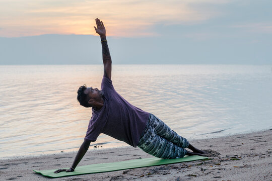 Male Practicing Yoga And Meditation Outside .