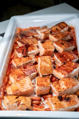 Salmon sirloin cooked on the grill and accompanied by baby carrots