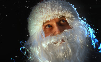 Portrait of Santa Claus looking at the falling snow.