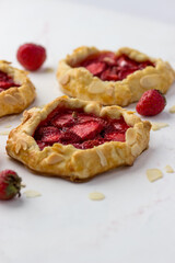 Mini biscuits with strawberries. Small berry pies on a white background.