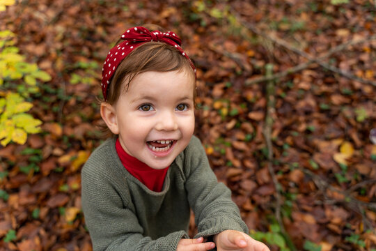 Happy little girl laugh in autumn