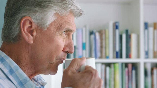Coffee, relax and senior man in retirement drinking delicious fresh cappuccino, espresso or caffeine. Face of happy retired elderly male taking in aroma of tea, thinking or planning future at home.