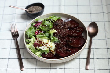 Healthy salad with beets and fresh leaves. Slimming salad with olive oil and lemon juice, beets and lettuce.
