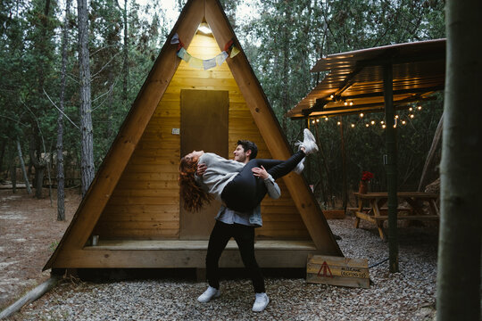 Young Man Carrying Woman In The forest