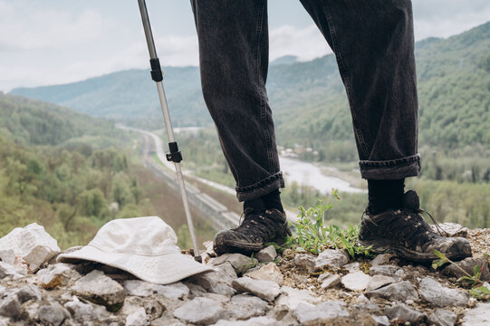 Unrecognizable hiker standing on border in nature