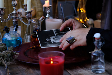 spiritualistic seance in salon of medium with old photographs, Female Fortuneteller, esoteric Oracle, longing for ancestors, communication with spirits, help ancestors, Family Ritual Scripts - obrazy, fototapety, plakaty