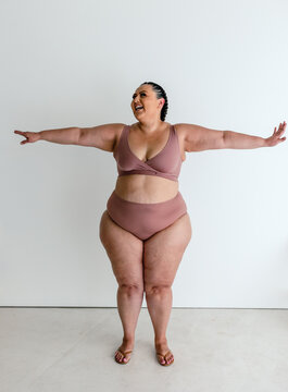 Smiling plus-size woman in bra and underwear 