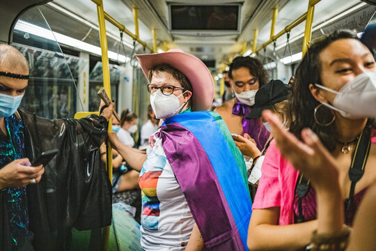Friends in a subway going to Pride