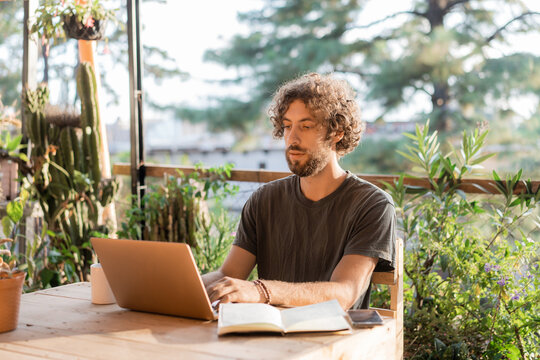 Man working with laptop on the terrace 