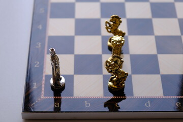 chess board with chess pieces. the king stand against rooks and knights. stalemate, pat position.