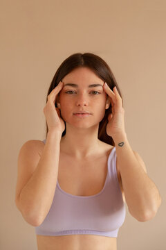 Woman Using Essential Oils In Her Temples