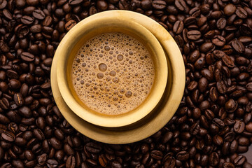 South Indian Filter coffee served in a traditional tumbler or cup over roasted raw beans