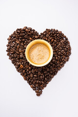 South Indian Filter coffee served in a traditional tumbler or cup over roasted raw beans