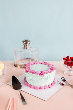 A birthday cake around vintage tableware with a matching background